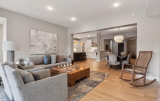 Image of living room looking towards the kitchen with a rocking chair near by.